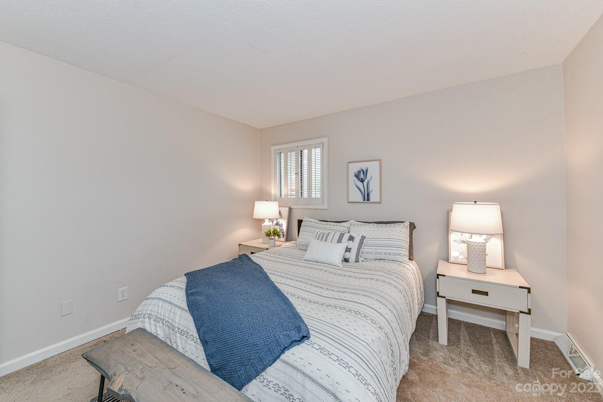 27046 Tidal Way Tega Cay, SC 29708 - Photo 10 of 20 a bedroom with a bed and a lamp