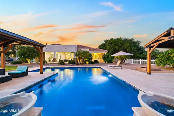 an aerial view of a house with a yard and garden