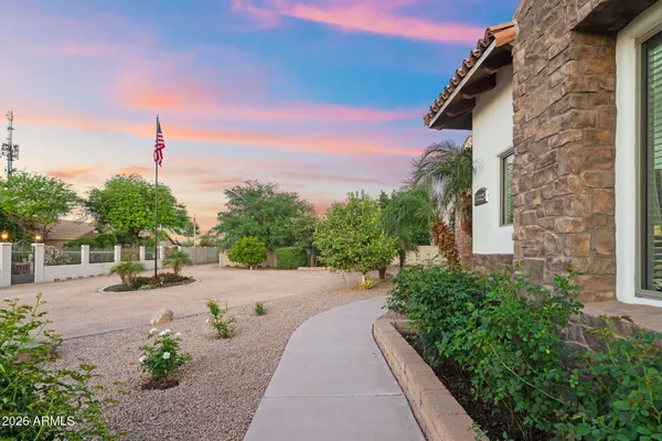a kitchen with stainless steel appliances kitchen island granite countertop a refrigerator a oven a stove and white cabinets with wooden floor