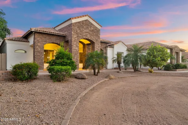 a kitchen with stainless steel appliances kitchen island granite countertop a stove and white cabinets