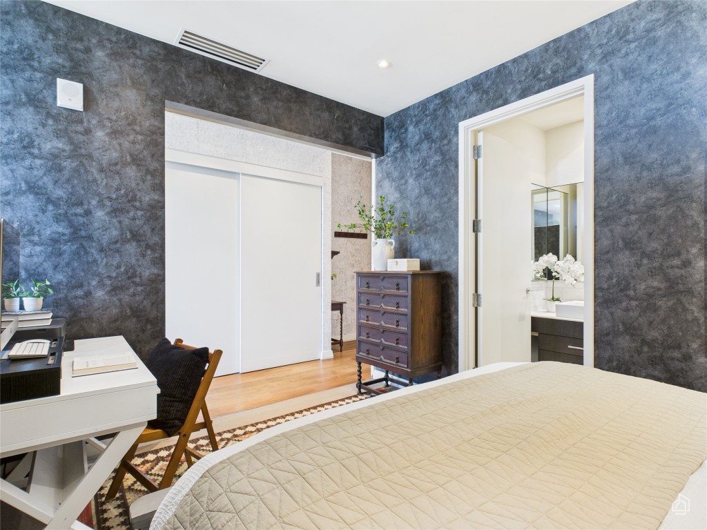 210 Lavaca Street, Unit 1809 Austin, TX 78701 - Photo 11 of 32 Bedroom with wood finished floors, a closet, recessed lighting, a desk, and ensuite bathroom
