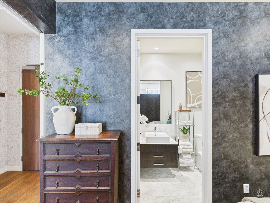 210 Lavaca Street, Unit 1809 Austin, TX 78701 - Photo 12 of 32 Bathroom featuring vanity and light marble finish floors