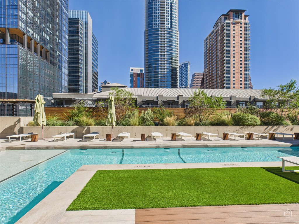 210 Lavaca Street, Unit 1809 Austin, TX 78701 - Photo 22 of 32 Community pool featuring a view of city and a lawn