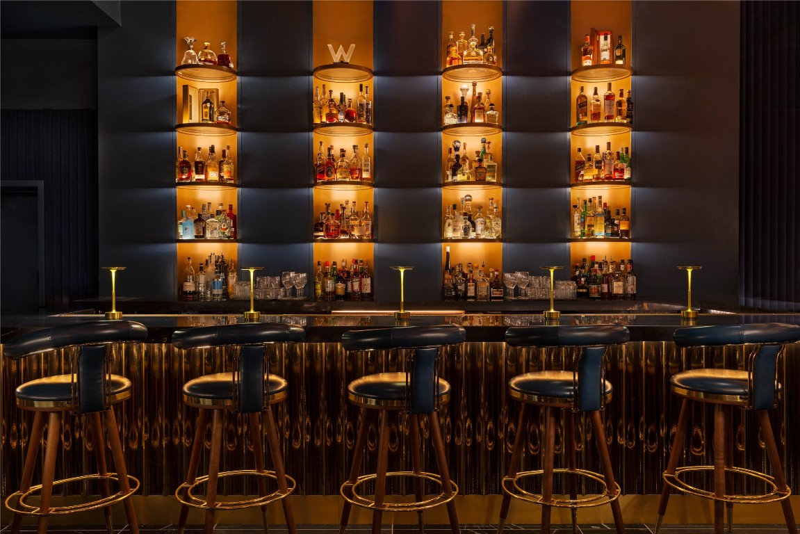 210 Lavaca Street, Unit 1809 Austin, TX 78701 - Photo 26 of 32 Indoor wet bar featuring dark brown cabinetry