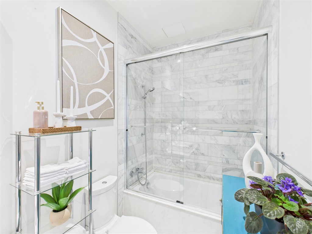 210 Lavaca Street, Unit 1809 Austin, TX 78701 - Photo 10 of 32 Bathroom featuring combined bath / shower with glass door and toilet
