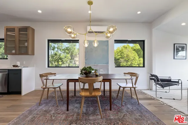 a dining room with furniture a chandelier and window