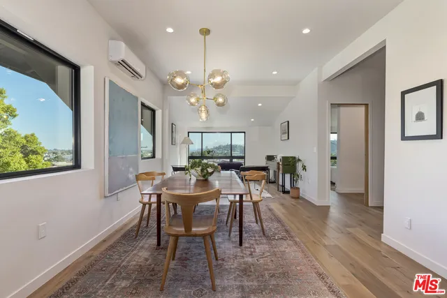 a view of a dining room with furniture window and wooden floor
