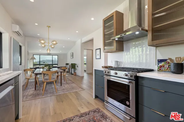 a kitchen with stainless steel appliances granite countertop a stove and a sink