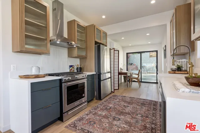 a view of backyard with table and chairs and potted plants
