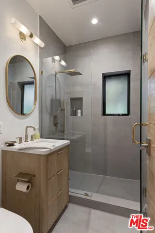 a bench sitting in backside of a house with potted plants