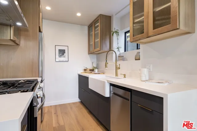 a kitchen with stainless steel appliances lots of counter space and a sink