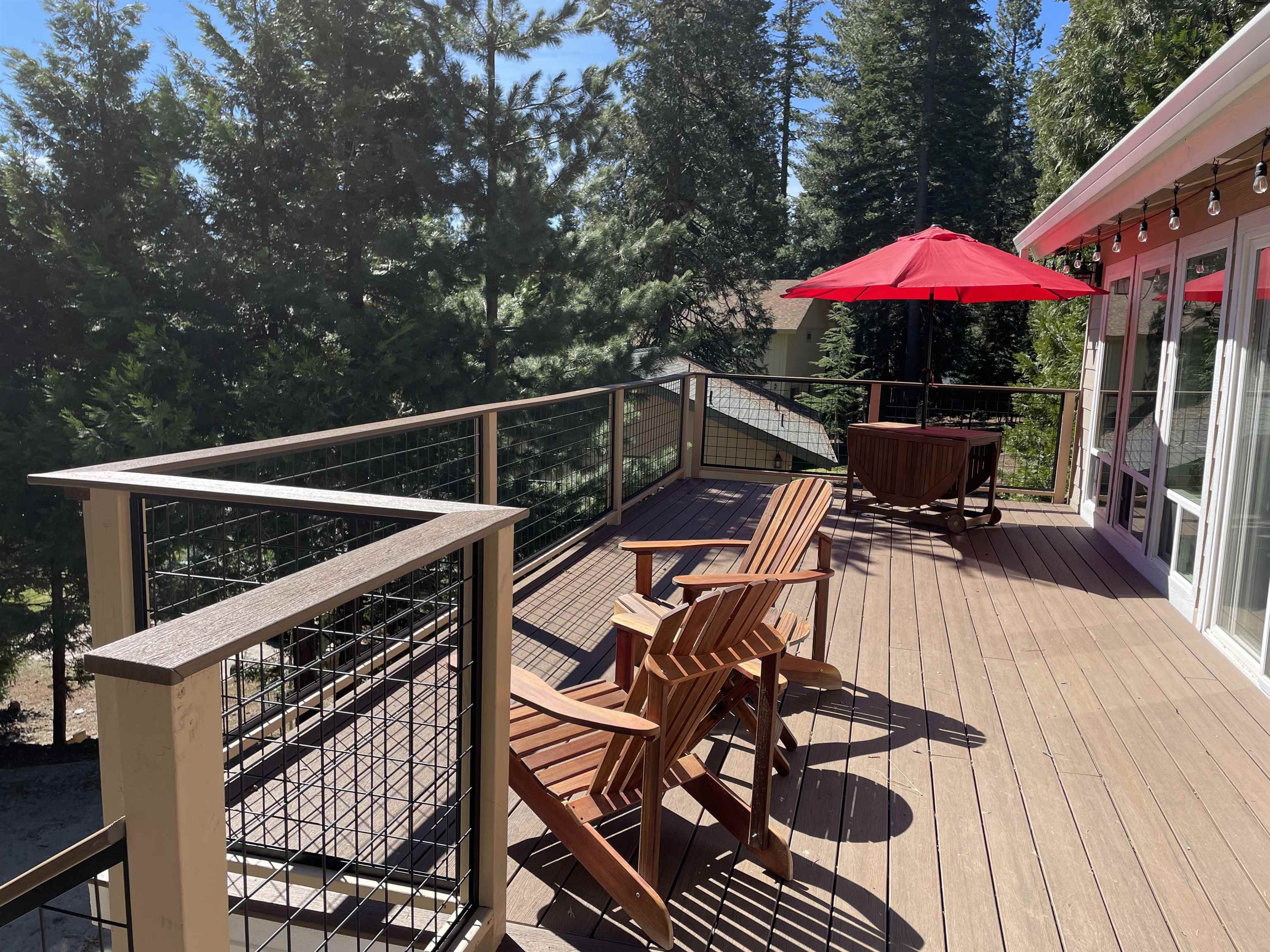 831 Timber Ridge Road Lake Almanor, CA 96137 - Photo 32 of 36 a view of a patio with furniture and umbrella