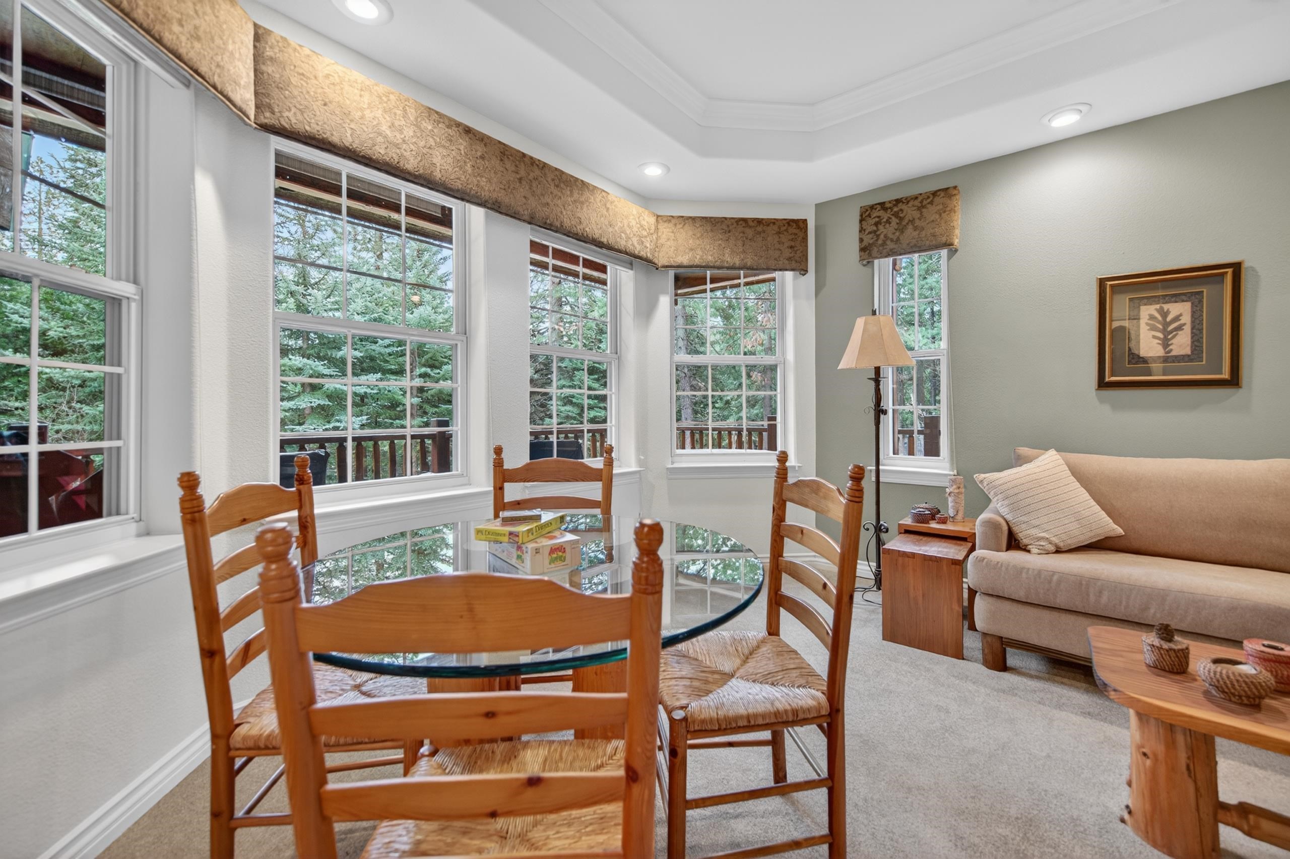1017 Timber Ridge Road Lake Almanor, CA 96137 - Photo 9 of 45 a dining room with furniture and a floor to ceiling window