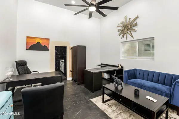 a living room with furniture ceiling fan and a window