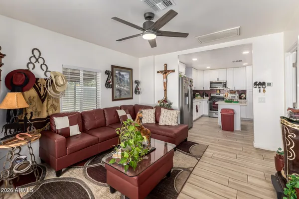 a living room with furniture and kitchen view