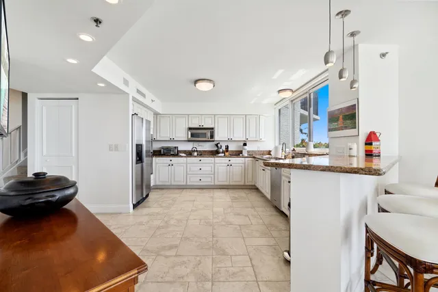 a kitchen with stainless steel appliances granite countertop a sink and cabinets