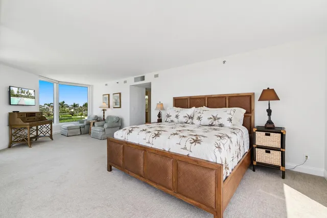 a bedroom with a large bed and a large window