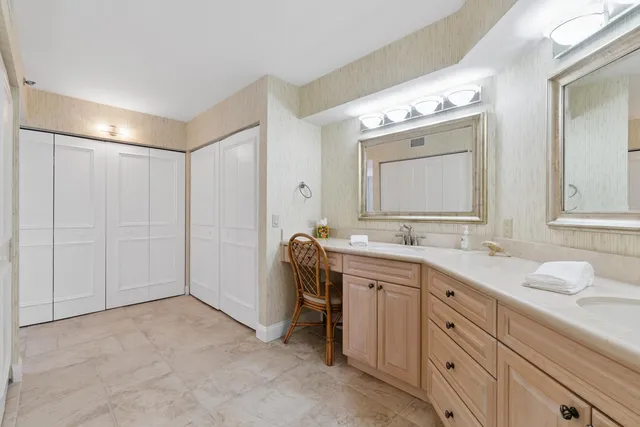 a bathroom with a double vanity sink mirror and