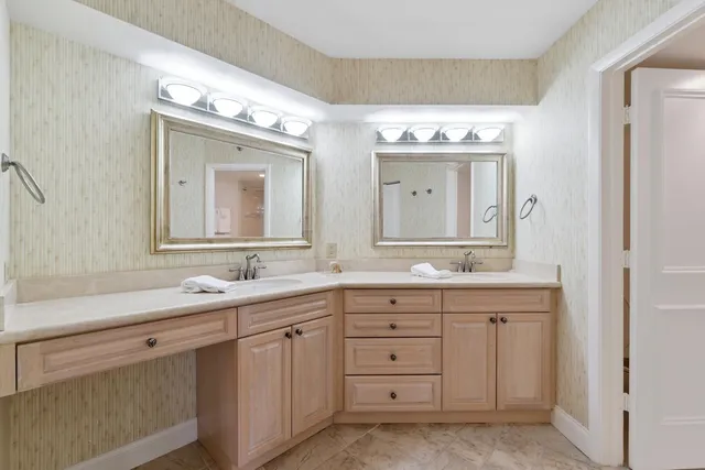 a bedroom with two beds and large window