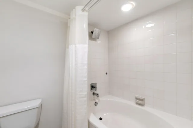 a spacious bedroom with two beds and a lamp