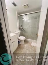 a bathroom with a shower and a toilet