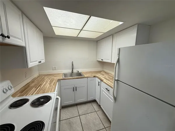 a kitchen with a sink a stove and cabinets