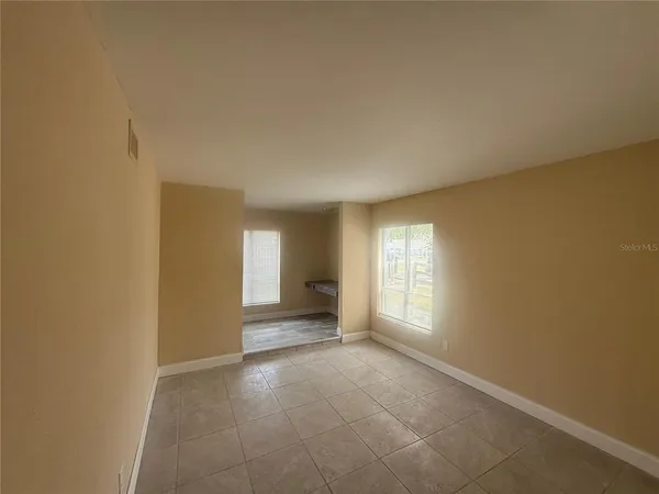 an empty room with windows and closet