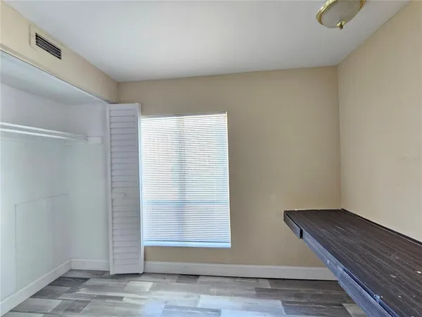 a view of wooden floor and closet in a room