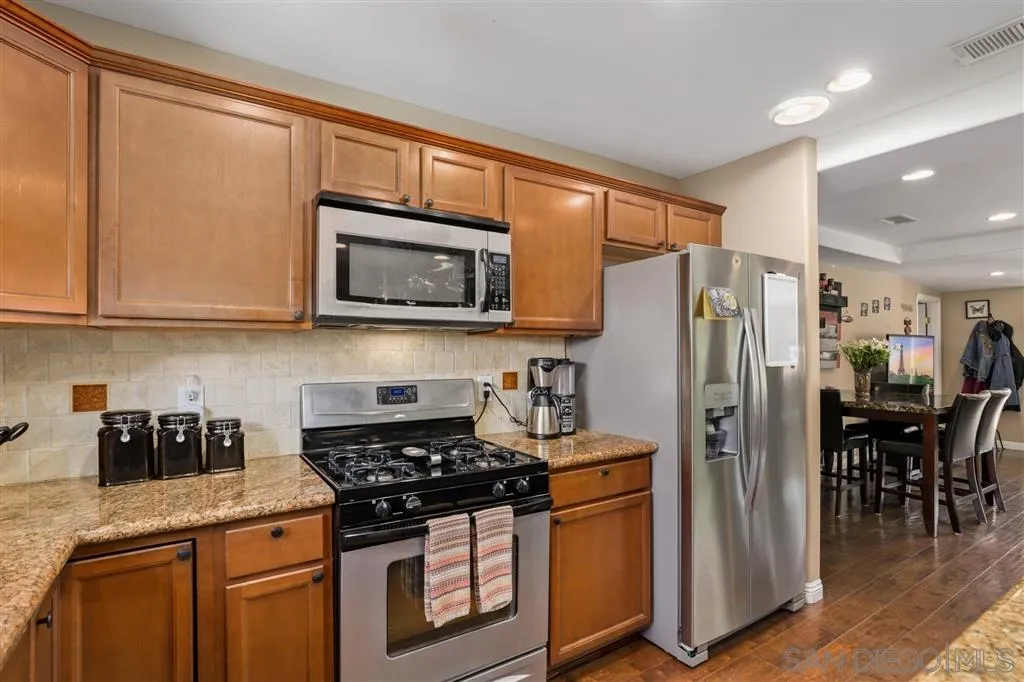 1021 Hillcrest View Lane Fallbrook, CA 92028 - Photo 14 of 24 a kitchen with stainless steel appliances granite countertop a refrigerator stove top oven and sink