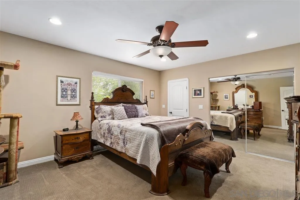 1021 Hillcrest View Lane Fallbrook, CA 92028 - Photo 9 of 24 a spacious bedroom with a bed and ceiling fan