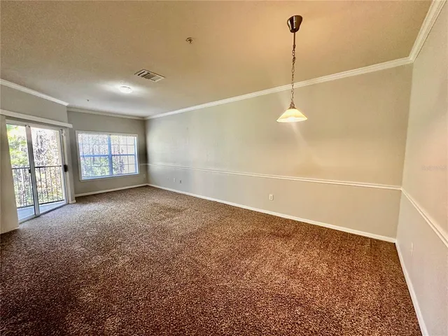 a view of an empty room with windows