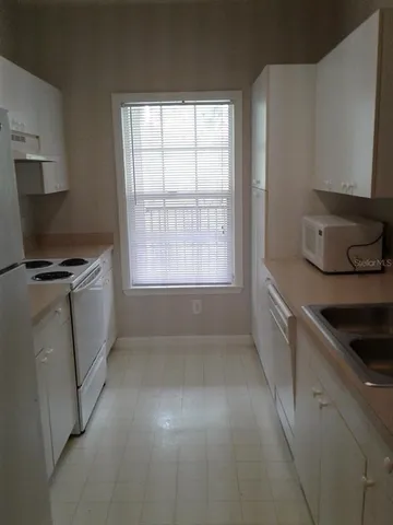 a kitchen with a stove and a microwave