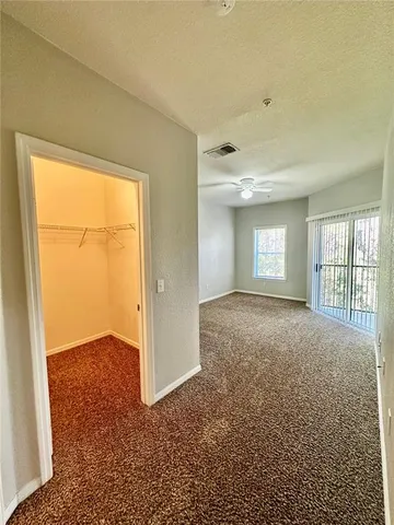 an empty room with windows and closet