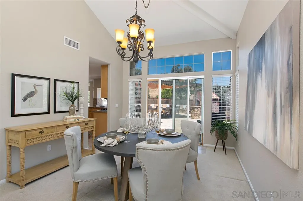 13615 Sunset View Road Poway, CA 92064 - Photo 5 of 24 a view of a dining room with furniture wooden floor and chandelier