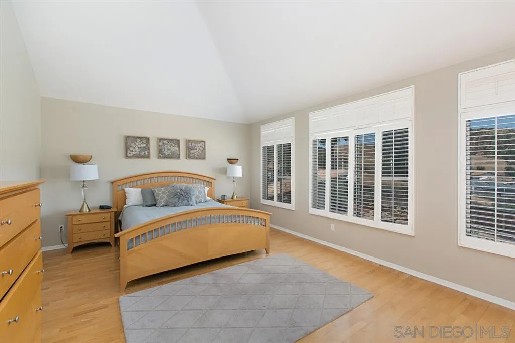 13615 Sunset View Road Poway, CA 92064 - Photo 8 of 24 a spacious bedroom with a bed and a large window