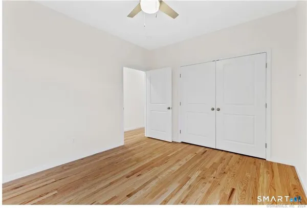 a view of an empty room with wooden floor