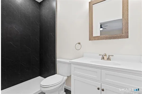 a bathroom with a sink a toilet and a mirror