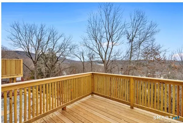 a view of wooden deck and a yard