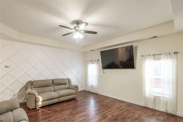 a kitchen with a table chairs microwave and cabinets