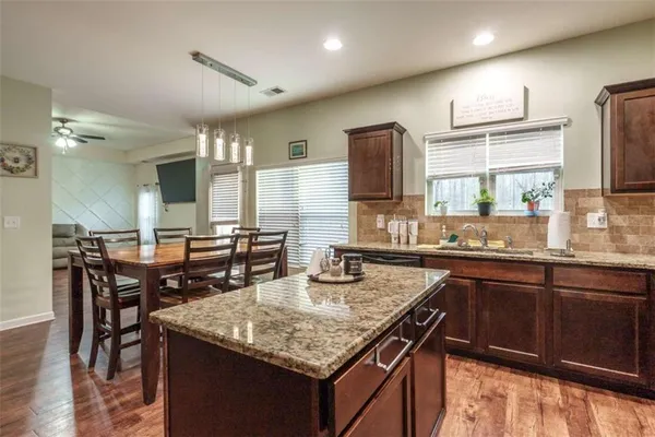 a kitchen with a stove a sink and a refrigerator