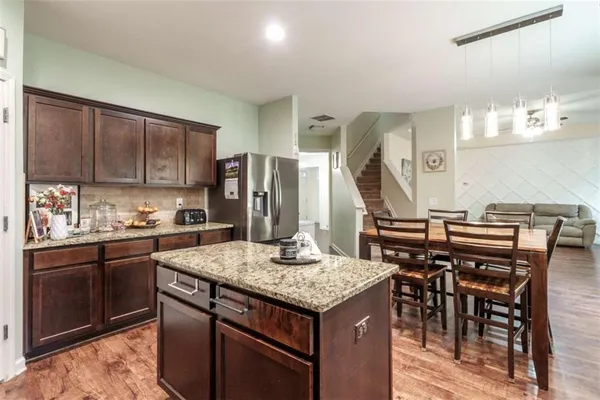 a kitchen with stainless steel appliances granite countertop a sink stove and cabinets