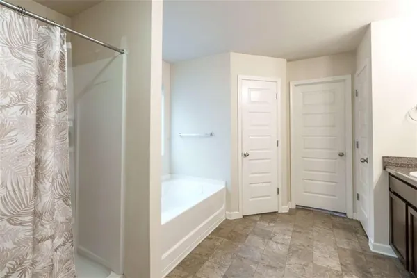 a room that has a bed and a chair in it
