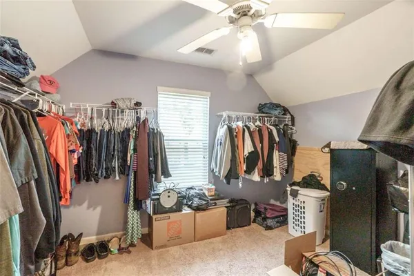 a bedroom with a bed a table and chair