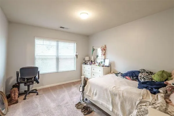 a room with a bed and cabinets