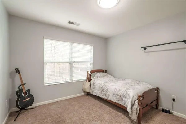 a bedroom with a bed and a cabinet