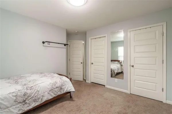 a bed sitting in a bedroom next to a window