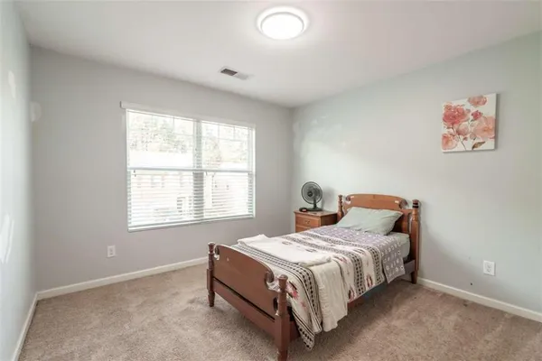 a bedroom with a bed and a table