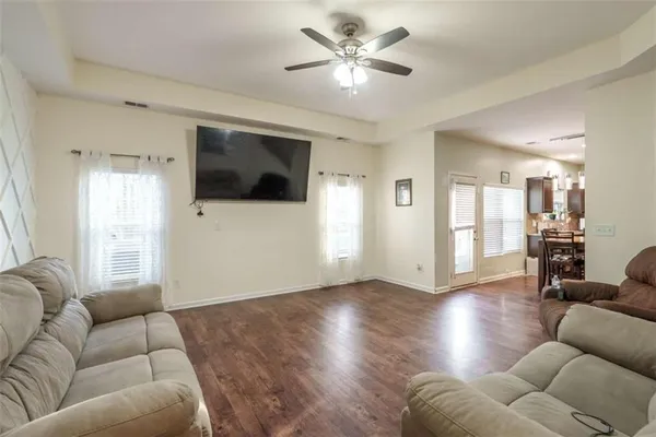 a living room with furniture and a wooden floor