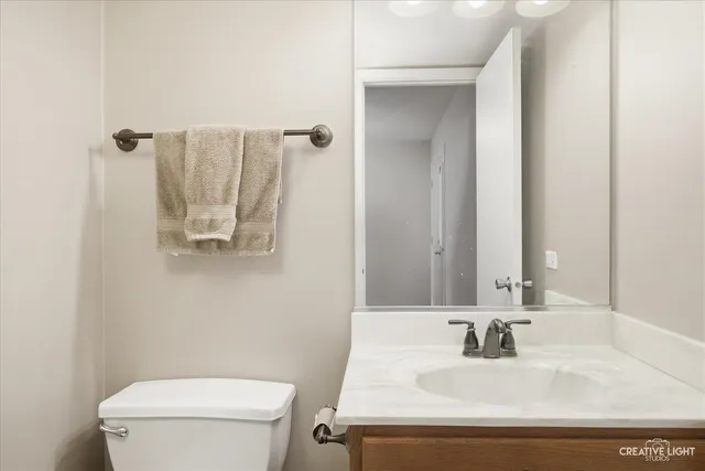 a bathroom with a sink toilet and mirror