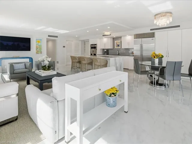 a living room with furniture and kitchen view